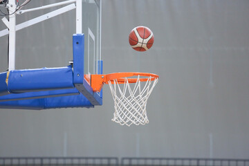 A basketball going into the hoop during a game