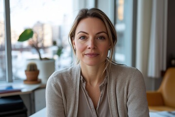 A fashionable woman exudes confidence and calmness in a cozy office, offering a glimpse into her professional life while embodying elegance and warmth in a winter scene.