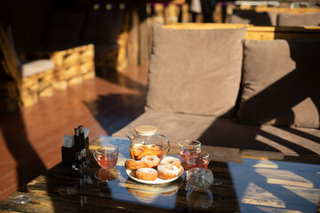 Baked donuts on table in restaurant. Delicious food. Details of establishment. Interior of restaurant.