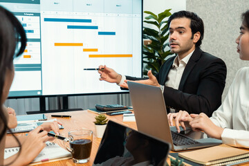 Project manager planning schedules for business task at meeting room, Gantt chart software show on...