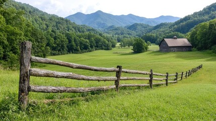 Mountain valley farm landscape; rustic barn, wooden fence, green pasture; idyllic rural scene; nature photography