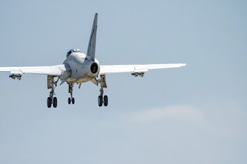 A fighter jet soaring through the clear blue sky, with no clouds in sight