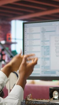 Vertical video Disappointed engineer in home office looking at UI on computer monitor, failing to properly execute programming code. Displeased IT worker seeing errors while using coding application