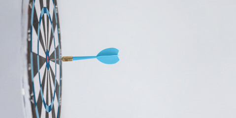 Blue dart embedded in the center of a target, symbolizing success, precision, and making the right moves to achieve goals effectively