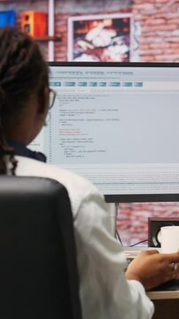 Vertical video Software developer at PC coding, creating software, implementing algorithms. IT expert in home office working with code editor, building applications, optimizing performance, camera B