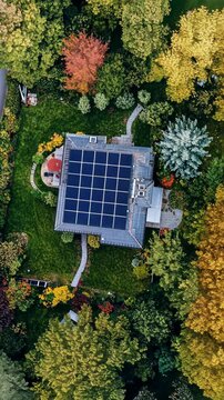 Bright solar panels capture energy on a modern home surrounded by vibrant autumn foliage in a suburban neighborhood
