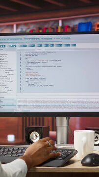 Vertical video Software developer at PC coding, creating software, implementing algorithms. IT expert in home office working with code editor, building applications, optimizing performance, camera A