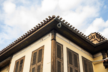 Traditional ottoman architecture with wooden shutters and clay tile roof