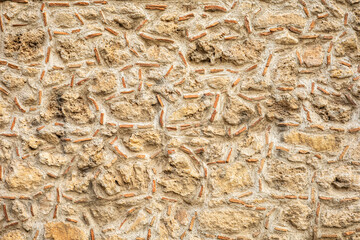 Texture of rustic stone and brick wall with irregular patterns