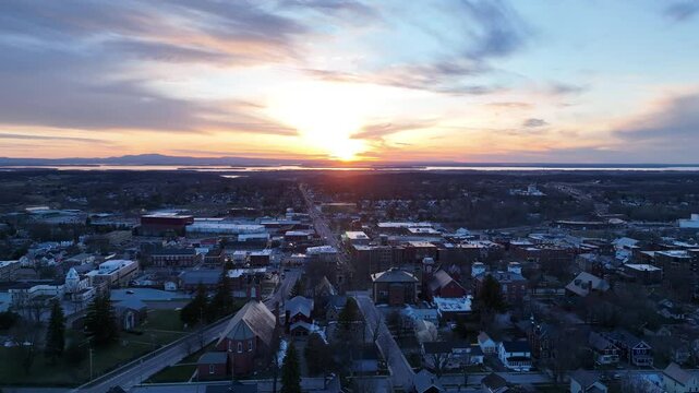 Saint Albans, Vermont drone video - Aerial drone footage flying over the downtown area of the small village of Saint Albans in northern Vermont with sunset over Lake Champlain