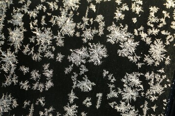 close-up of frost on the windshield of the car in the dark