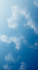 Fototapeta premium Serene Blue Sky with Scattered Fluffy White Clouds Natural Background Image