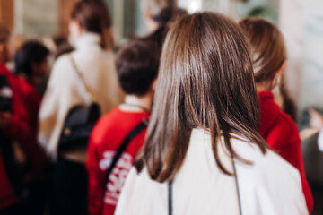 Group of kids children on excursion in a museum gallery, school pupils and students tour with...
