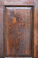 Antique wooden door panel with cracked varnish and rich texture