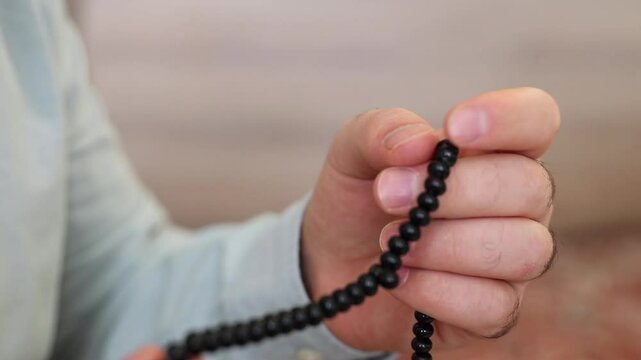 Man worship with black rosary