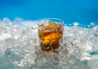 glass of ice cold cola on ice
