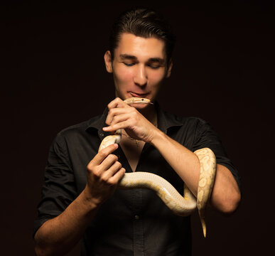 yellow python in a man's arms