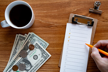 Desk with dollar bills and checklist. As an eye catching image for financial or marketing themed content.