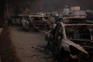 Cars destroyed in the palisades fire blocking the road