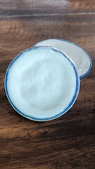 Street food, dessert, cup of coconut milk, pandanus on wooden floor