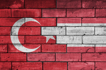 colourful painted big flag of turkey and flag of austria on a massive old brick wall background....