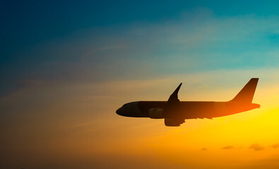 Passenger plane flying in the sky at sunrise. Airplane flying over mountains. Travel concept by plane and international travel.	
