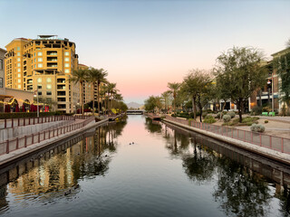 Sunset falls on downtown Scottsdale Arizona waterfront via the salt river canal project
