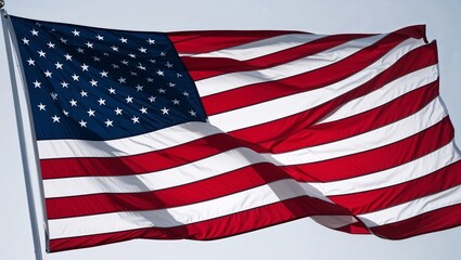Obraz premium A beautifully flowing American flag against a bright sky backdrop.