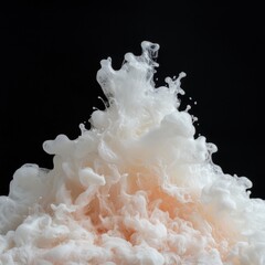 Abstract white and peach ink swirling in water, black background