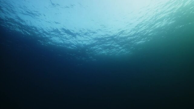 Light Rays In Dark Underwater Ocean Abyss Background Darkness Dread Mystery Magical Deep Ocean Waves Stormy Water Sun Light Beams Illuminating Ocean Depths. Water deep blue calm surface. Copy space
