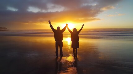 Fototapeta premium Happy senior man and woman old retired couple walking a beach at sunset
