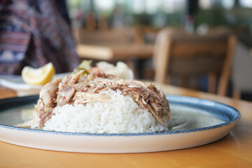 Boiled chicken, steamed rice, pink plate.