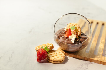 A dessert with strawberries and whipped cream in a glass bowl