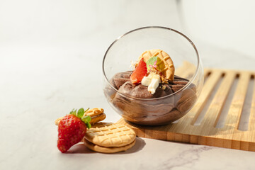 A dessert with strawberries and whipped cream in a glass bowl