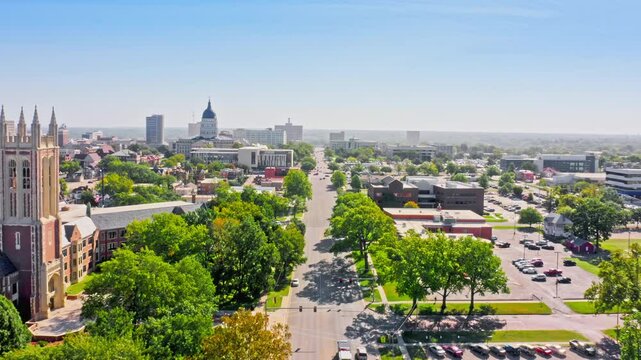 Aerial establishing shot of the Kansas Statehouse and Topeka skyline with forward motion along 10th street. Topeka is the capital city of the U.S. state of Kansas and the county seat of Shawnee County
