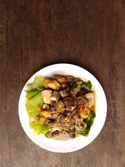 stir fry mushrooms with green mustard and egg as garnish 