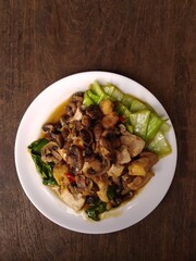 stir fry mushrooms with green mustard and egg as garnish 