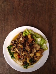 stir fry mushrooms with green mustard and egg as garnish 