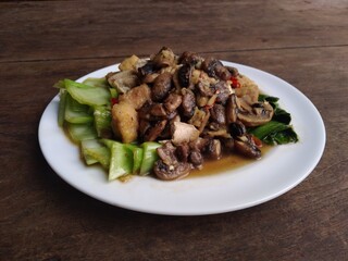 stir fry mushrooms with green mustard and egg as garnish 