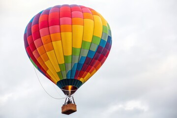 Naklejka premium Colorful Hot Air Balloon Soaring Through a Cloudy Sky for Travel and Adventure Promotion