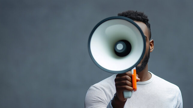 Man holding megaphone, face obscured