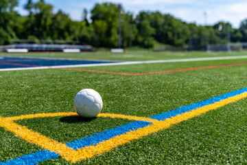 Corner Line of an outdoor multi sport synthetic turf , soccer, training field with soccer ball.	