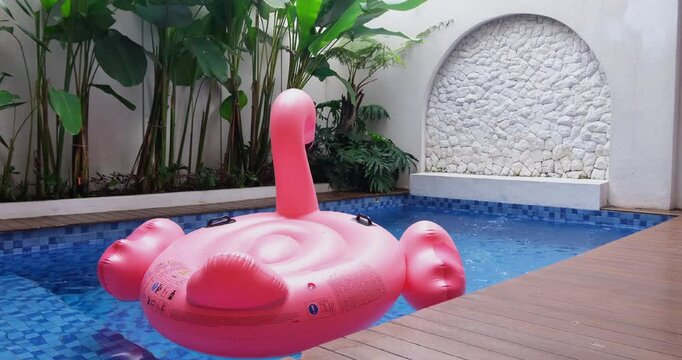 Villa swimming pool area with white walls and green leaves
