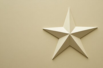 Decorative five point star made of lightweight material on a smooth beige background in a modern...