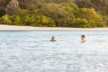 Kids swimming in the Currumbin Creek at Palm Beach in Queensland