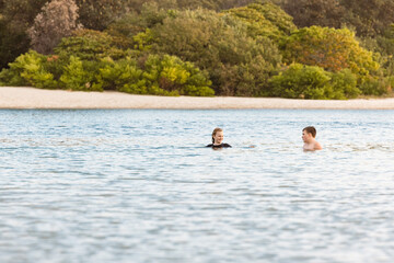 Kids swimming in the Currumbin Creek at Palm Beach in Queensland