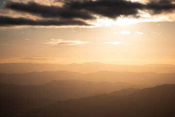 mountain range orange sunset clouds sky