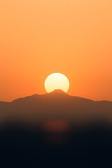 Sunset over mountain silhouettes.