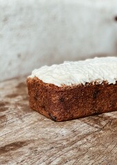 Cake with frosting on rustic background, homemade
