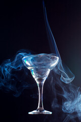 levitating wine glass full of smoke on a black background